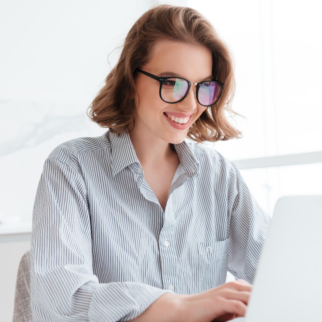 close-up-portrait-cheerful-bunette-woman-glasses-using-laptop-computer-while-working-home (1)